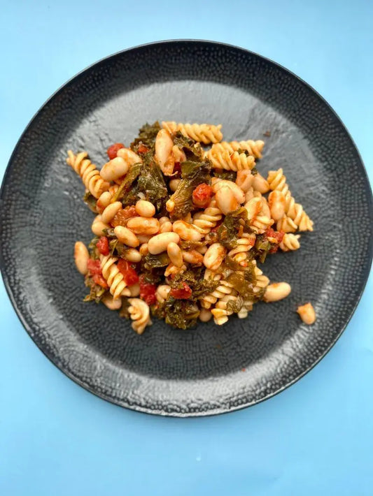 White Bean Sage Pasta with Kale in Tomato Sauce | 488 Kcal White Bean Sage Pasta with creamy cannellini beans, rich tomato sauce, kale, and sage—488 Kcal, 21g protein, 82g carbs, and 14g fats. Deliciously nutritious!